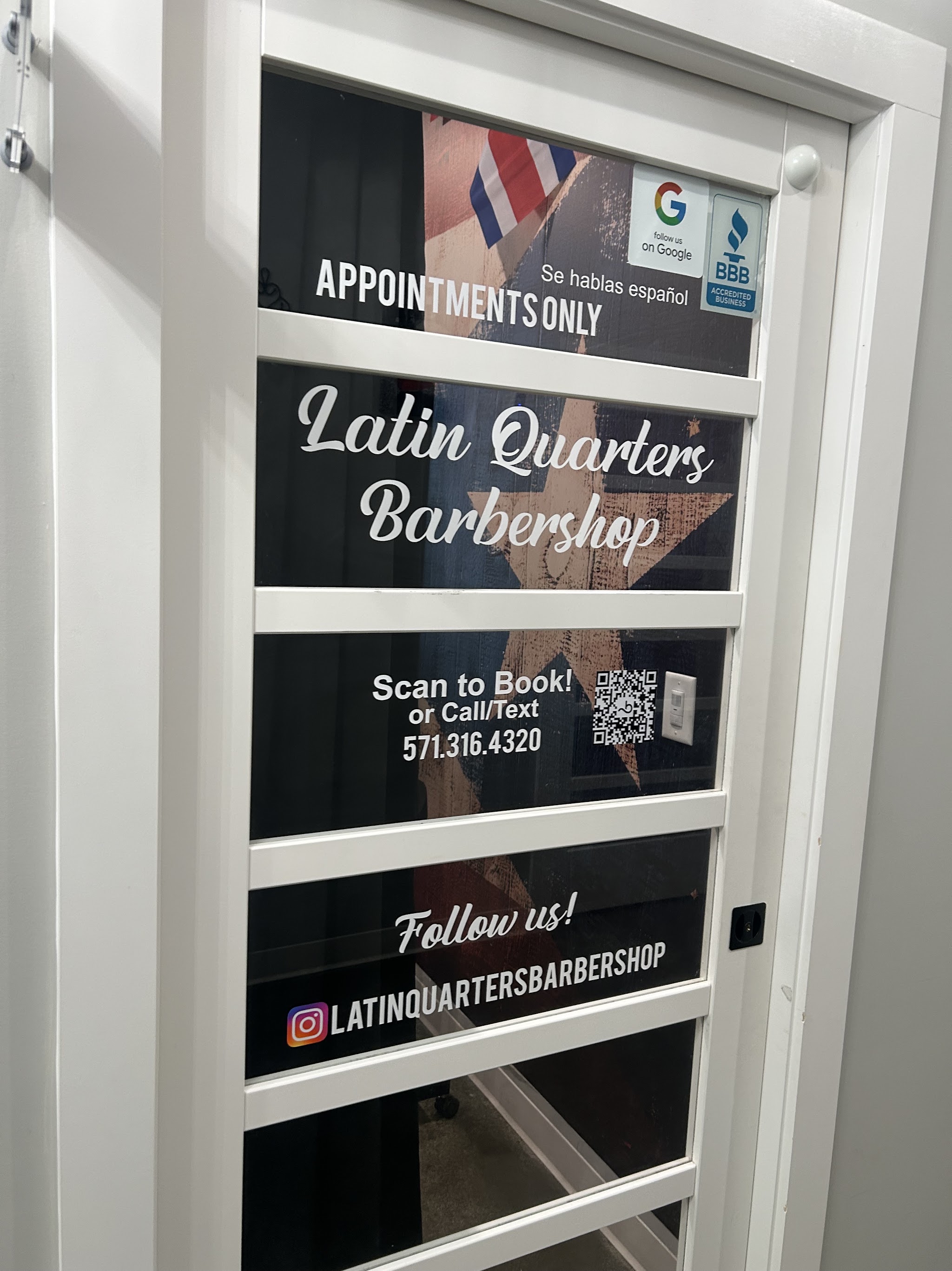 The shop door with the Latin Quarters Barbershop sign, appointments only, se habla español