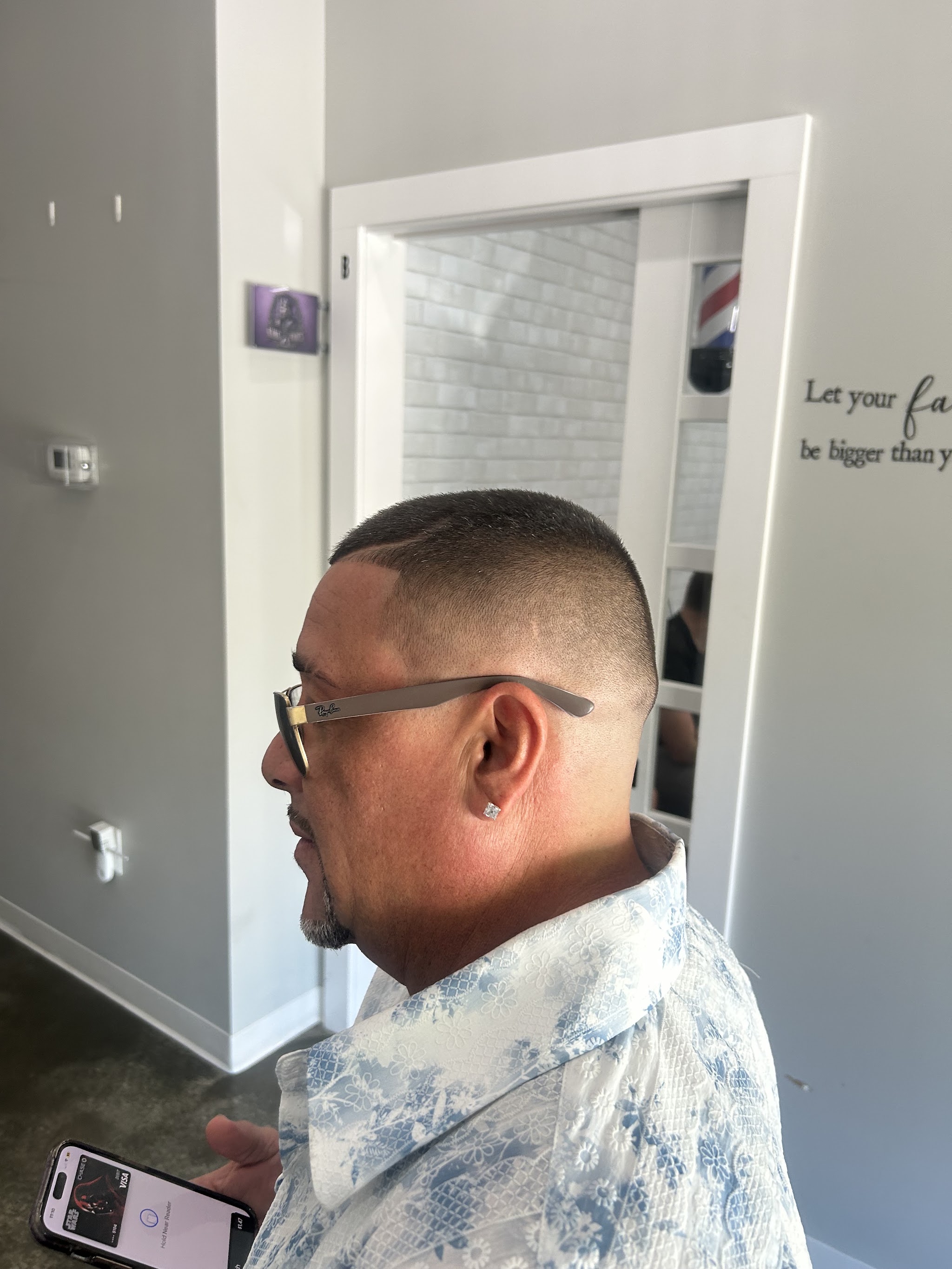 Tight high fade on a grown man, side profile
