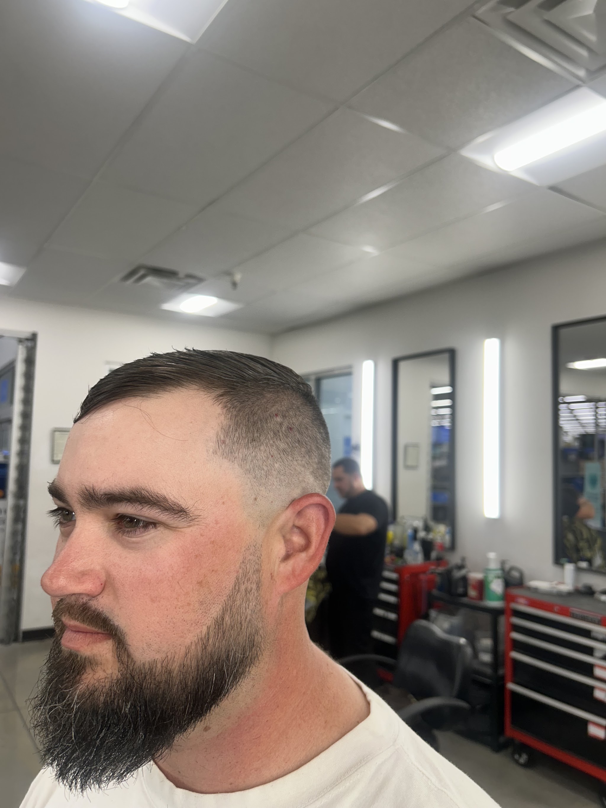 Short fade finished with a full beard