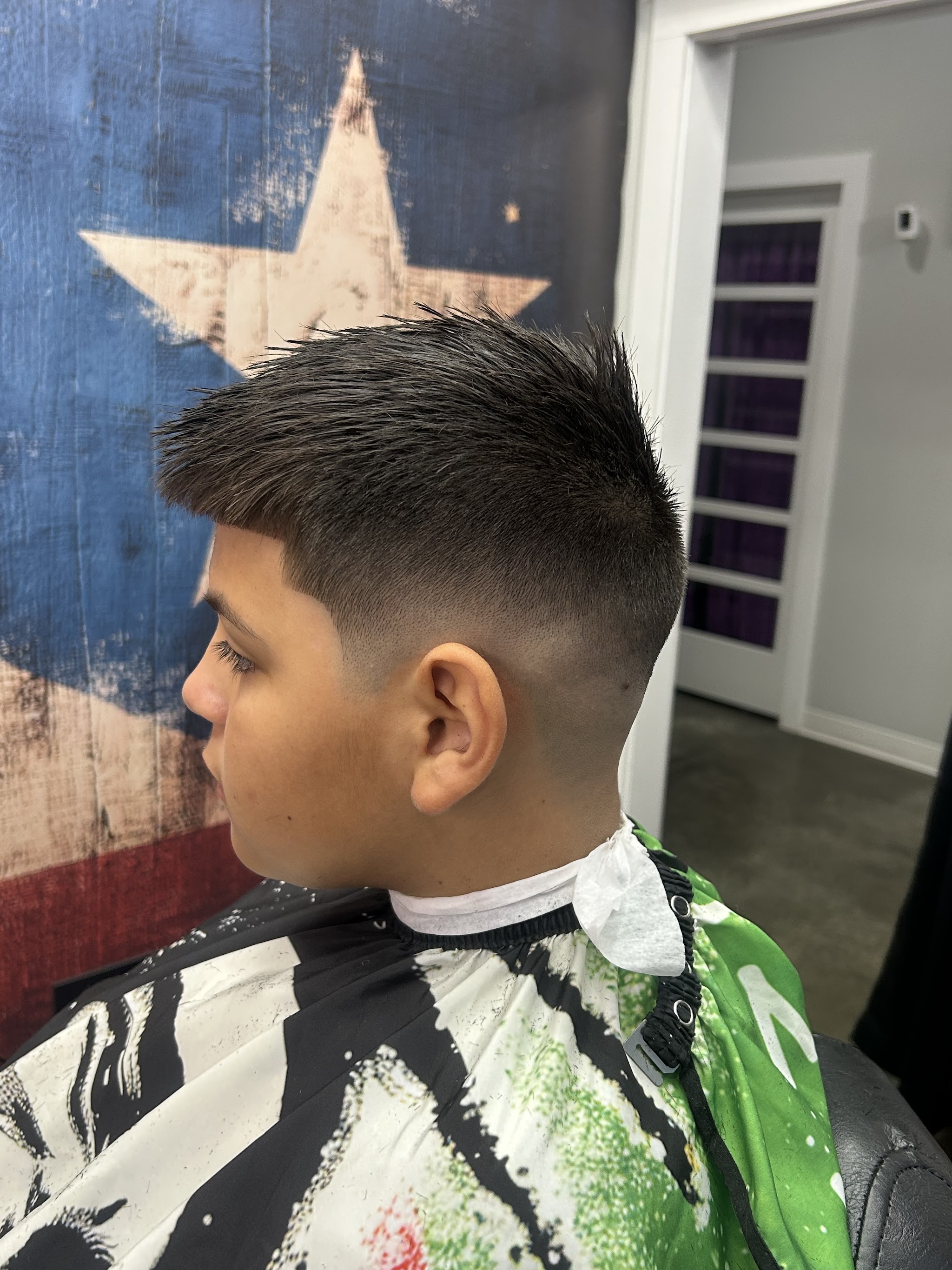 Clean fade with a textured top on a young client